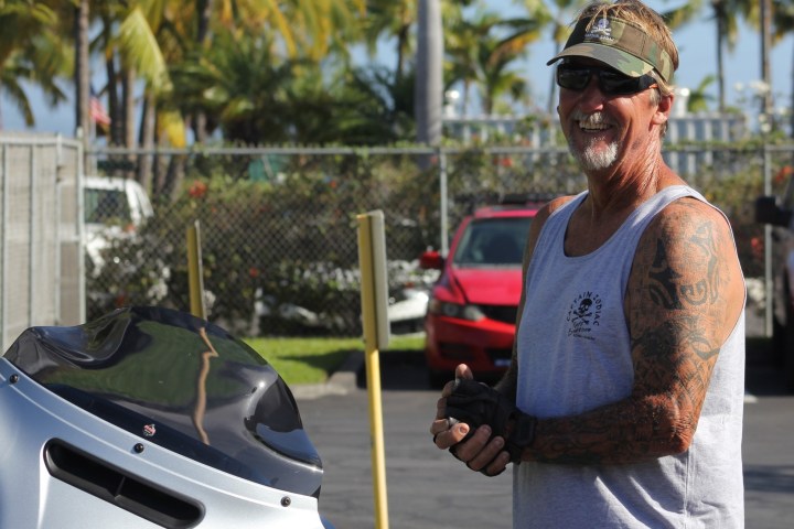 a man standing next to a car